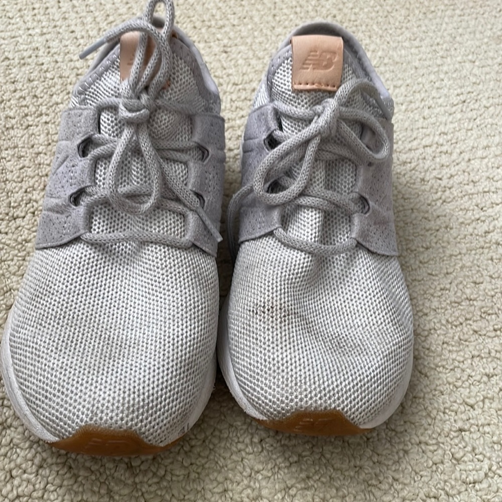 grey new balance shoes with brown tags
